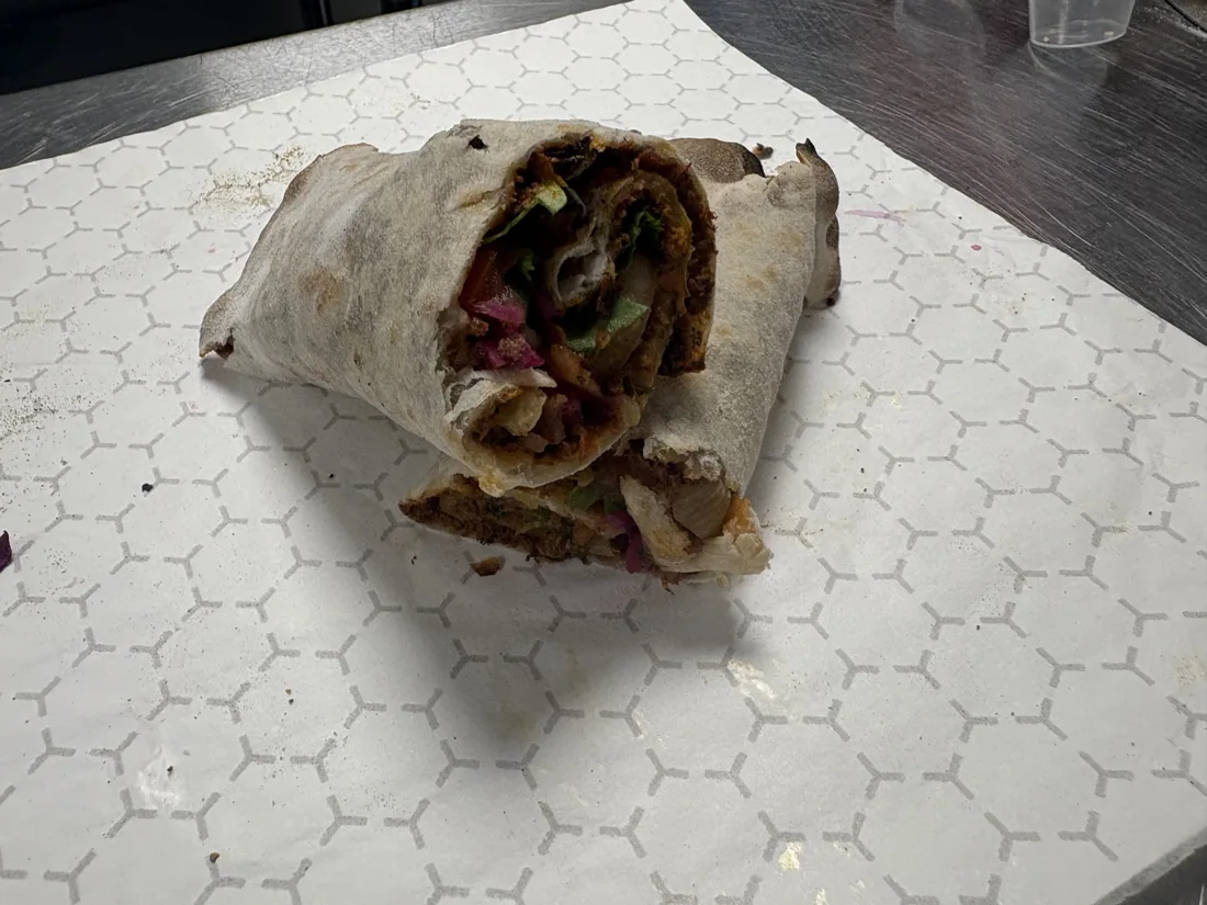 A close-up of the handmade Turkish köfte sandwich